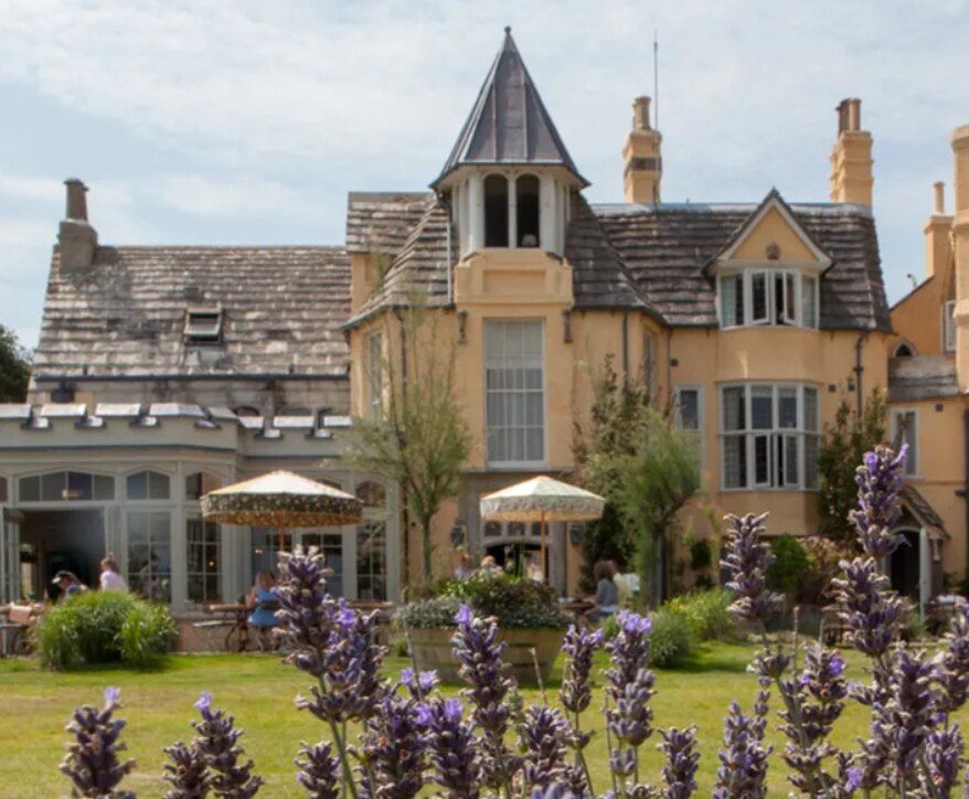 A Pig hotel, an ochre Victorian country house with lavender in the foreground